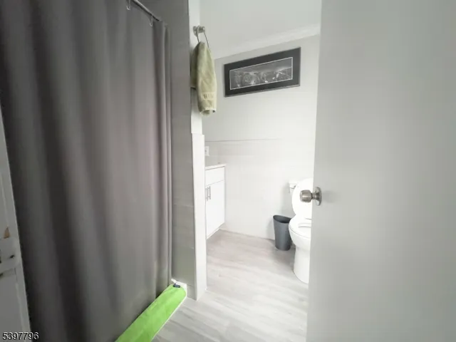 a view of a hallway with wooden floor and a curtain