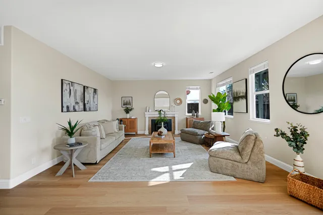 a living room with furniture or couch and a mirror