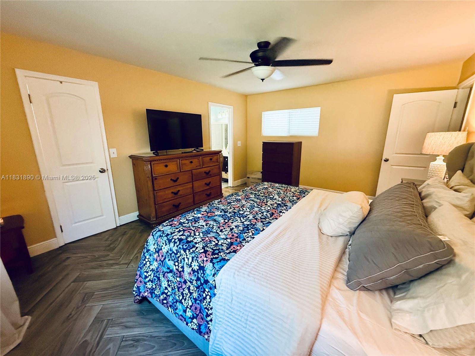 2980 Southwest 82nd Way Davie, FL 33328 - Photo 13 of 39 a bedroom with a bed and a flat screen tv