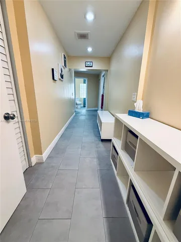 a view of a hallway with seating area