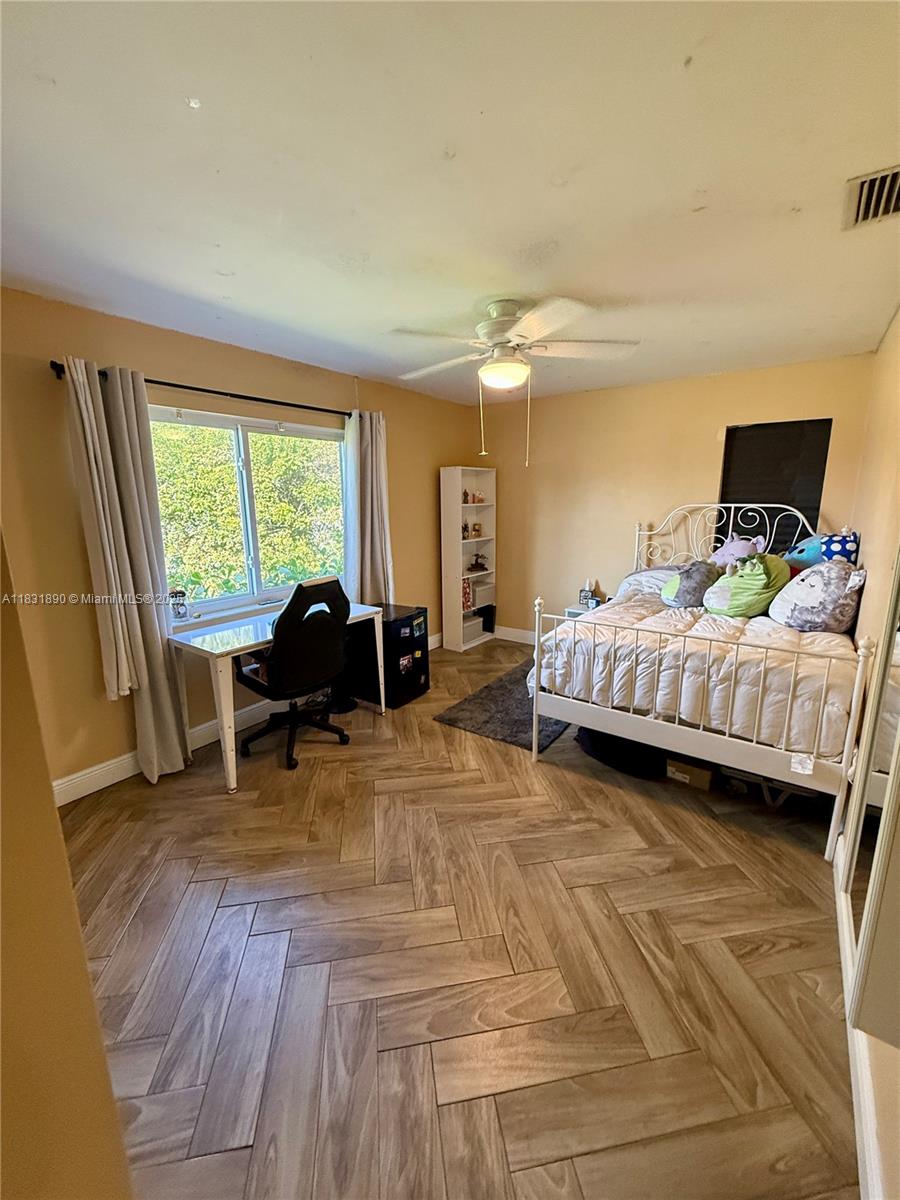 2980 Southwest 82nd Way Davie, FL 33328 - Photo 24 of 39 a bedroom with a bed and a large window