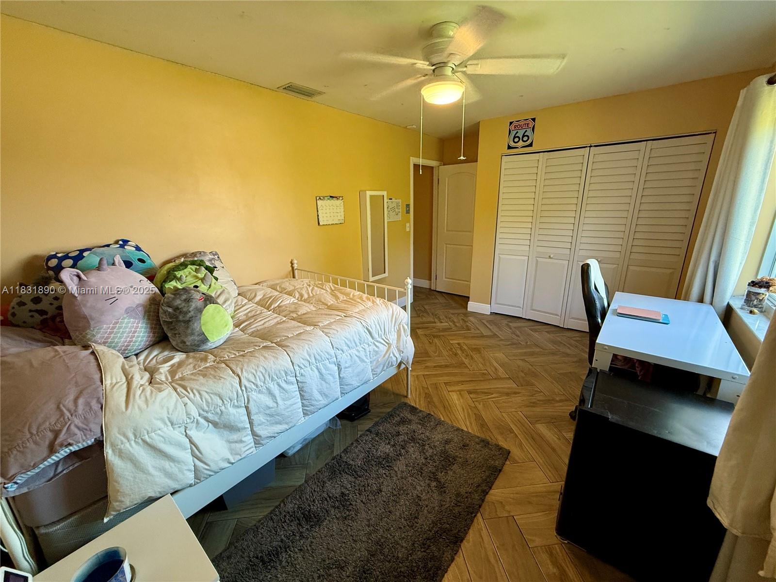 2980 Southwest 82nd Way Davie, FL 33328 - Photo 25 of 39 a bedroom with a bed and wooden floor