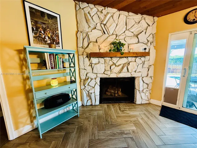 a living room with a fireplace and a window