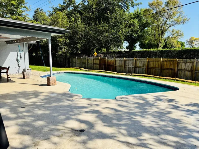 a view of a swimming pool with a yard