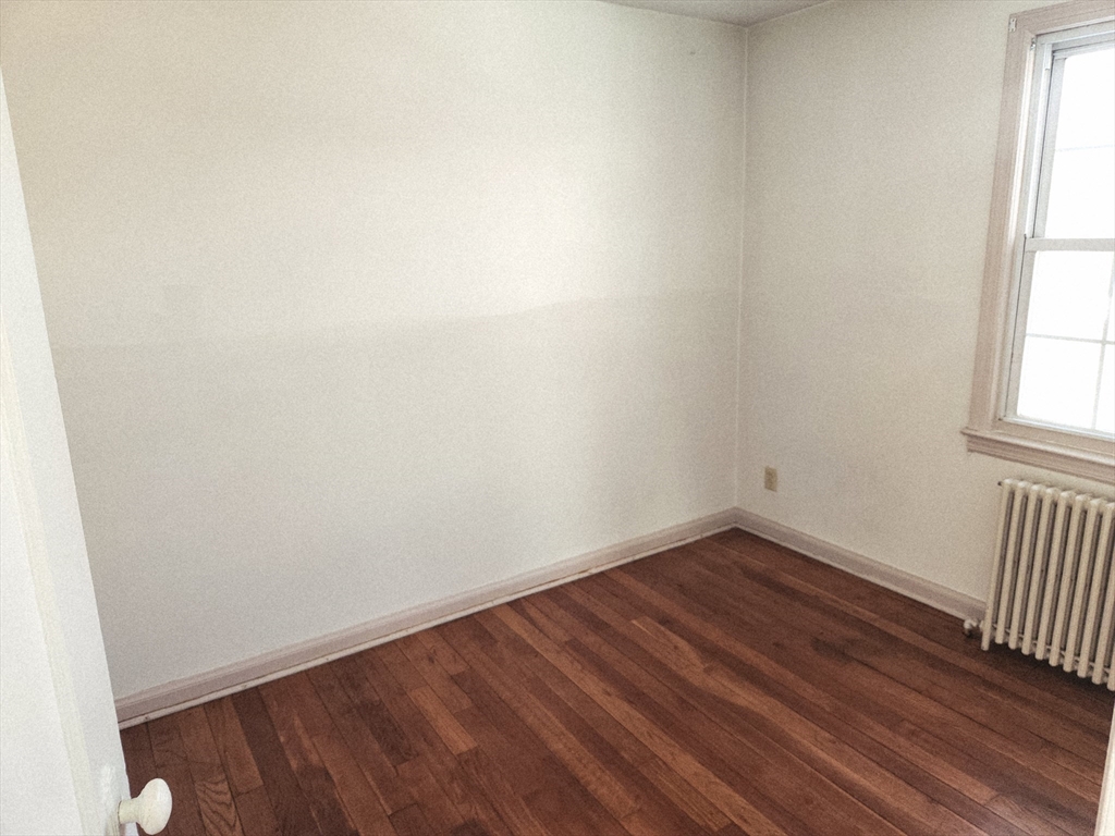 456 Cold Spring Avenue, Unit 2A West Springfield, MA 01089 - Photo 11 of 13 an empty room with wooden floor and windows