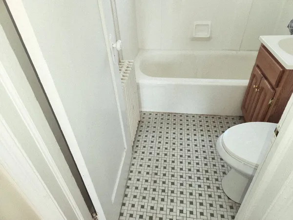 a bathroom with a sink a toilet a mirror and shower