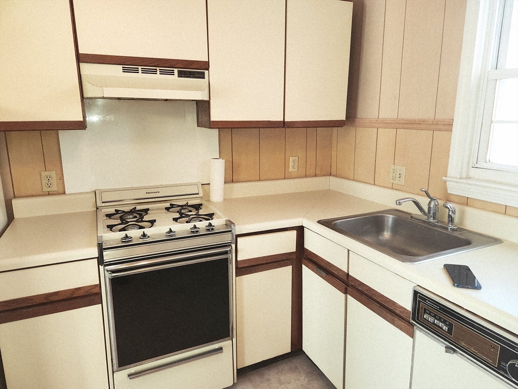456 Cold Spring Avenue, Unit 2A West Springfield, MA 01089 - Photo 4 of 13 a kitchen with a stove cabinets and a sink