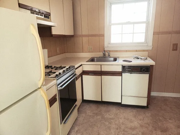 a kitchen with a stove and a sink