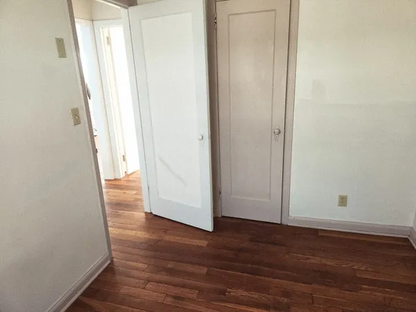a view of a room with wooden floor