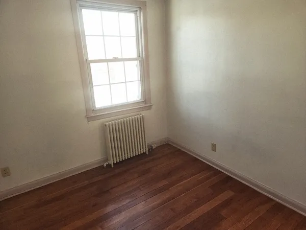 an empty room with wooden floor