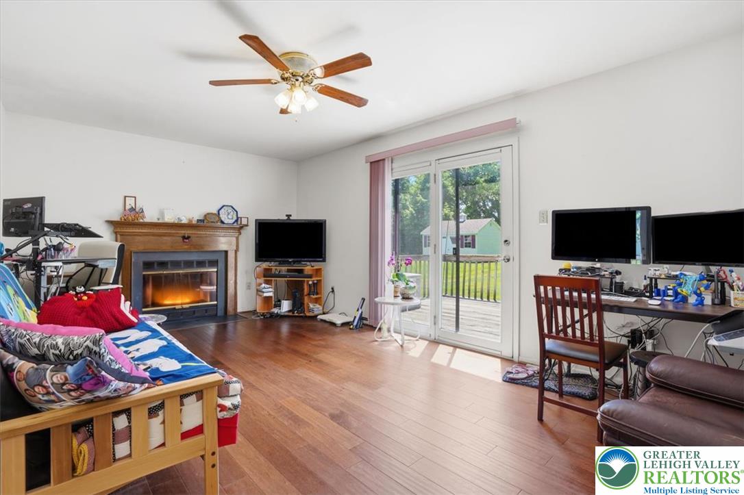 808 Hunter Road Easton, PA 18040 - Photo 5 of 41 A well-lit family room features rich hardwood flooring and a warm, inviting wood burning fireplace and sliding doors to large deck