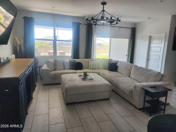 a living room with furniture and a flat screen tv