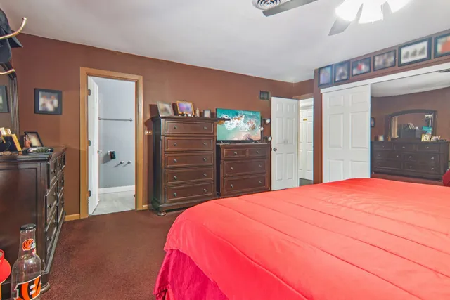 a bedroom with a bed and a dresser