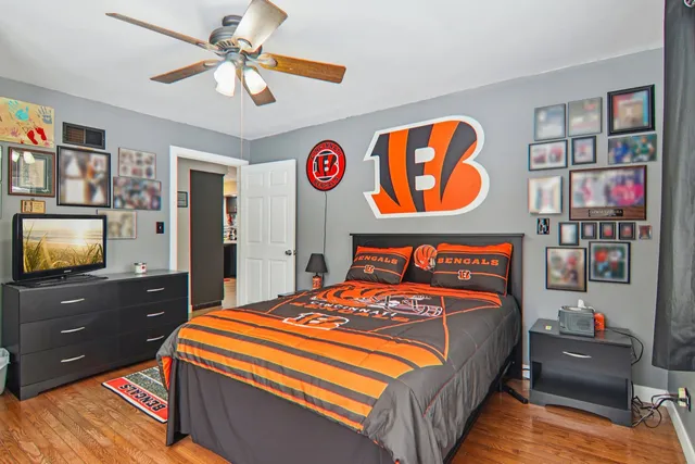 a bedroom with a bed and a flat screen tv