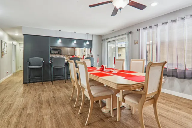 a view of a dining room with furniture and chandelier