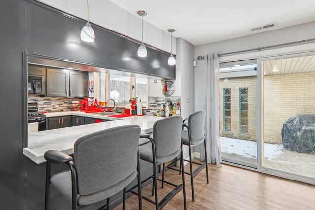 a dining room with furniture and wooden floor