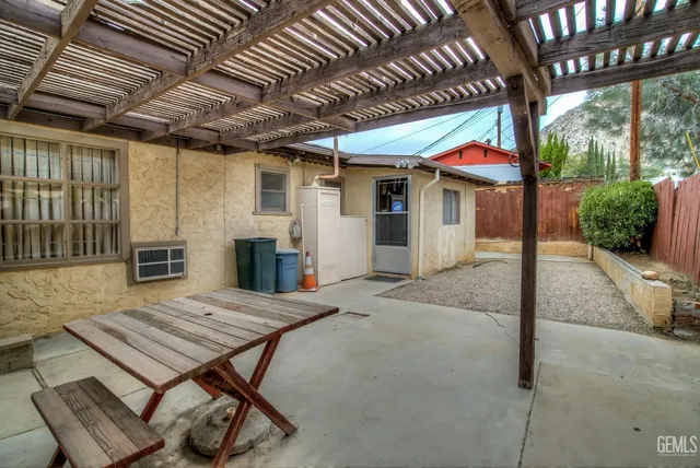a view of a patio with table and chairs with wooden floor and fence