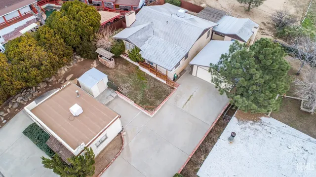 an aerial view of a house with a backyard