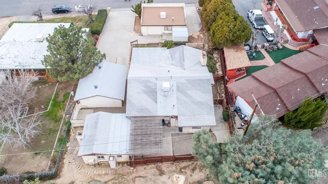 an aerial view of a house with a yard and a fountain
