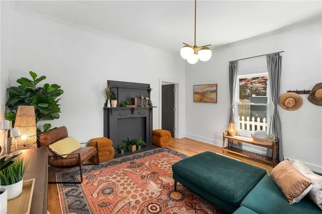 a living room with furniture and a potted plant