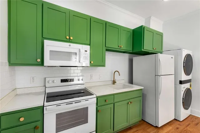 a kitchen with a sink cabinets and washing machine