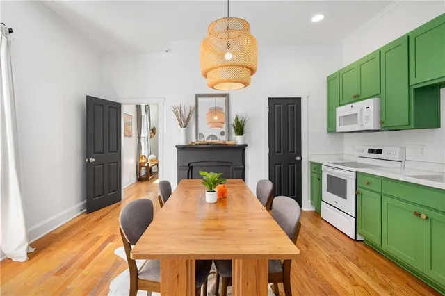 a view of a dining room with a table and chairs