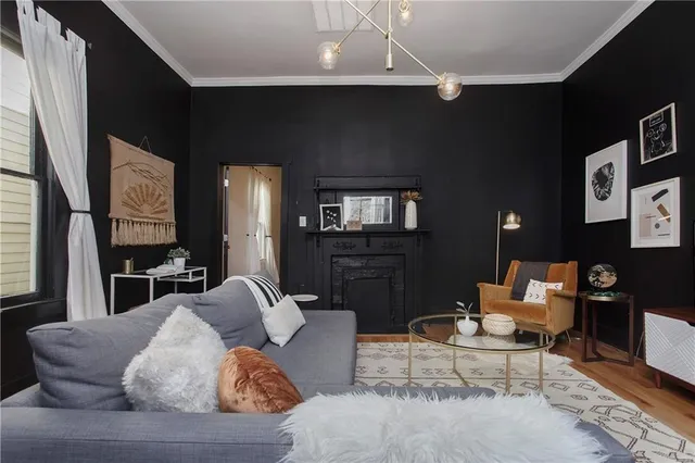 a living room with furniture and a chandelier