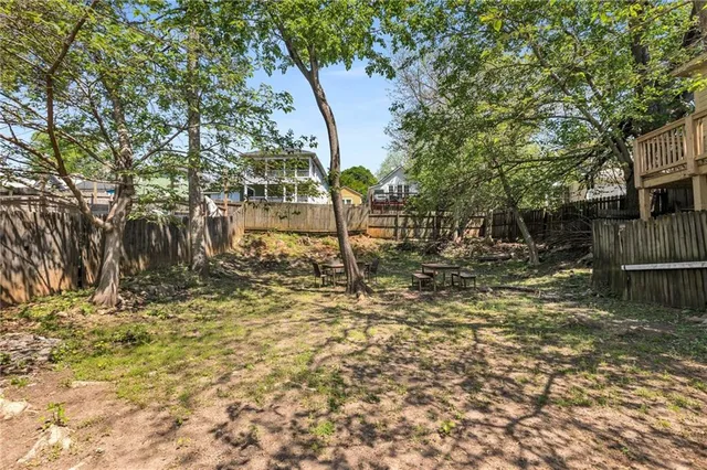 an aerial view of residential houses with outdoor space and street view