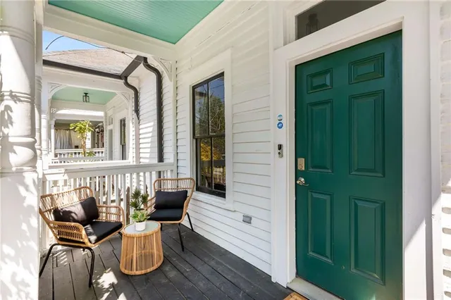 a view of a balcony with furniture and wooden floor