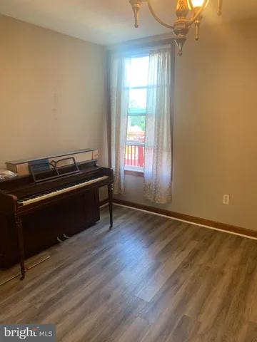 a room with a window and wooden floor