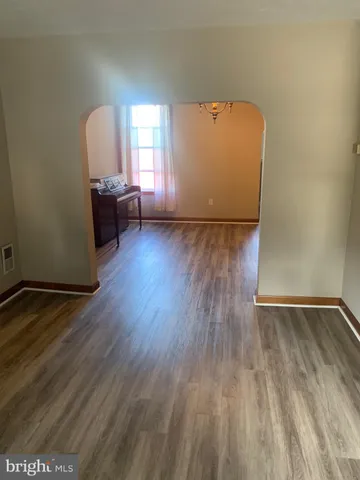a view of room with wooden floor and cabinet