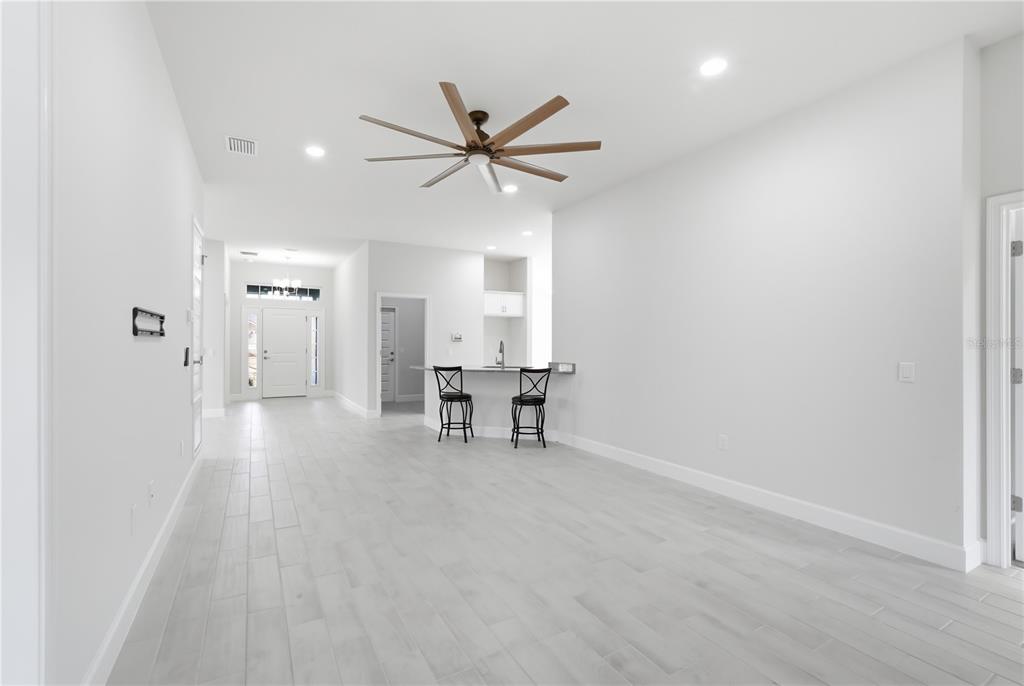 12945 Ogden Glade Road Dade City, FL 33525 - Photo 13 of 26 a view of a livingroom with a ceiling fan and hardwood floor