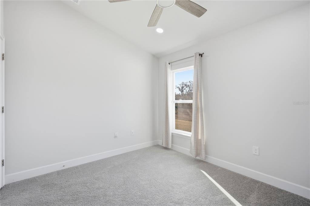 12945 Ogden Glade Road Dade City, FL 33525 - Photo 16 of 26 an empty room with closet and windows