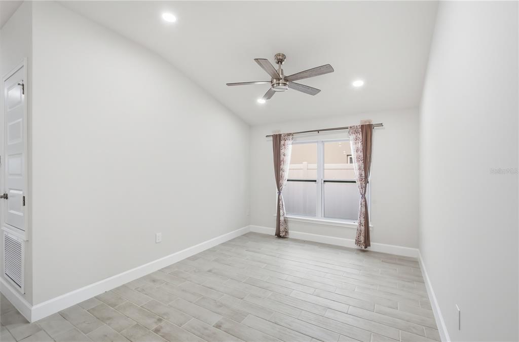 12945 Ogden Glade Road Dade City, FL 33525 - Photo 6 of 26 wooden floor in an empty room