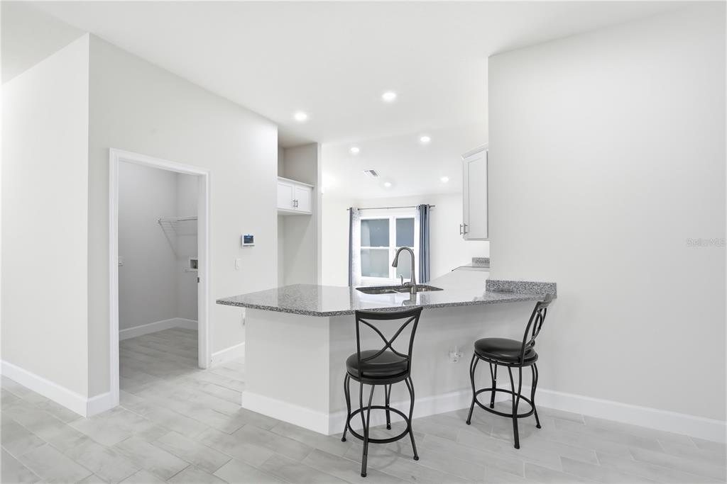 12945 Ogden Glade Road Dade City, FL 33525 - Photo 7 of 26 a view of a kitchen with dining area and windows