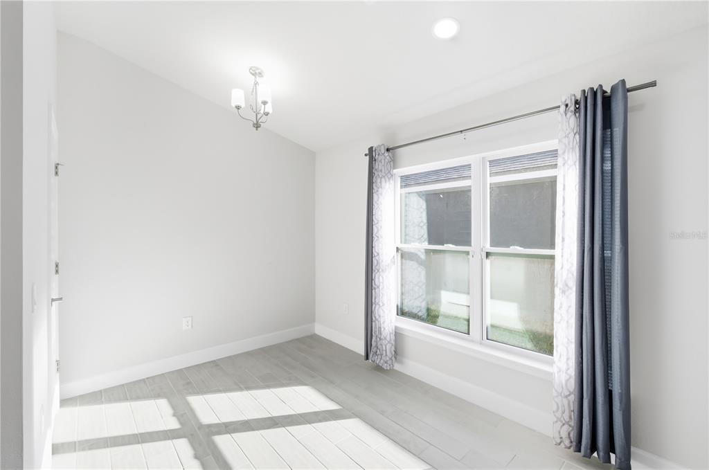 12945 Ogden Glade Road Dade City, FL 33525 - Photo 9 of 26 a view of an empty room with a window