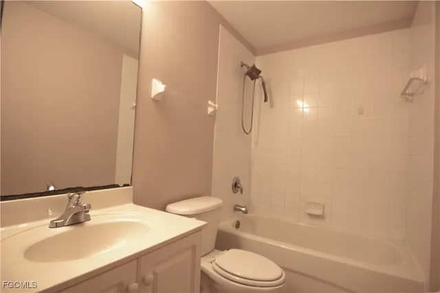 a bathroom with a sink toilet vanity and shower