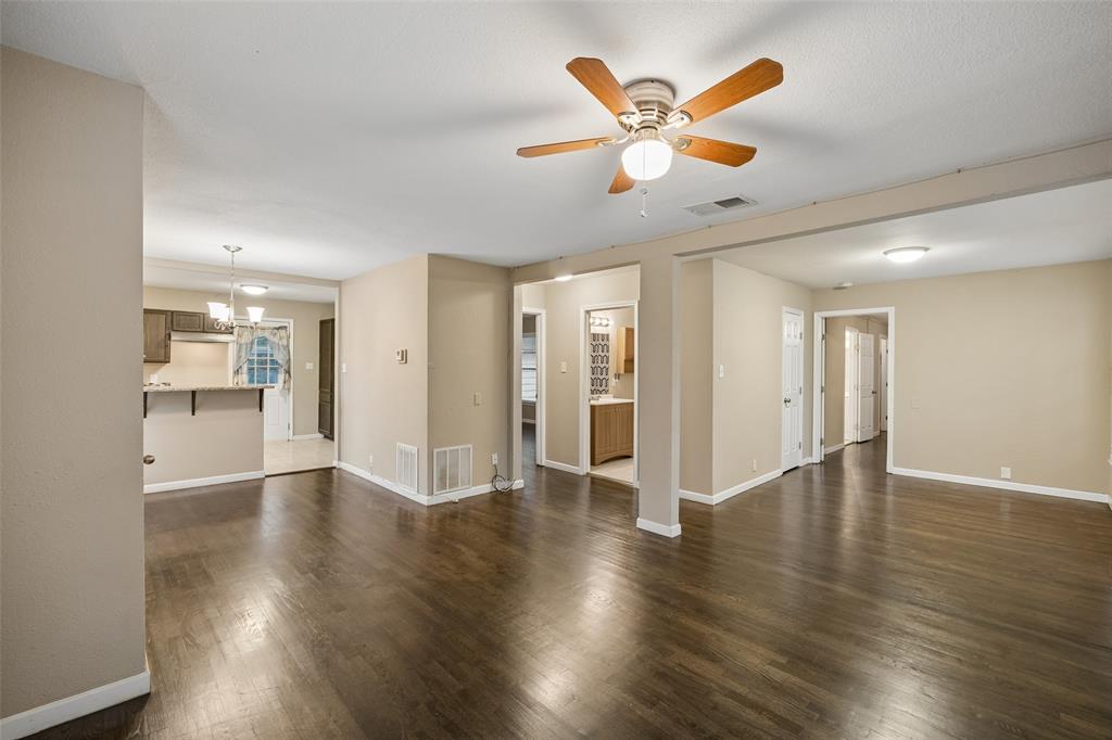 117 Moon Street Cleburne, TX 76033 - Photo 6 of 28 a view of an empty room with wooden floor and a ceiling fan