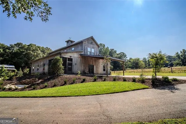 a front view of a house with a garden and yard