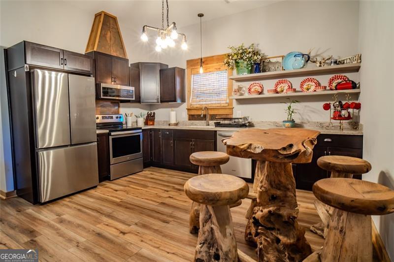 1700 Beaverdam Road Madison, GA 30650 - Photo 12 of 50 a kitchen with stainless steel appliances granite countertop a sink a stove and a refrigerator