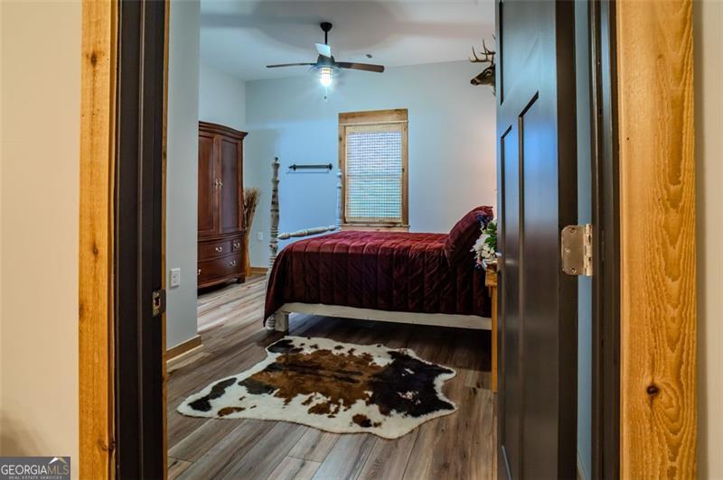 1700 Beaverdam Road Madison, GA 30650 - Photo 22 of 50 a bedroom with a bed and a mirror