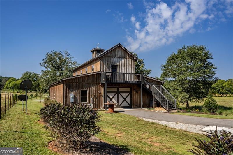 1700 Beaverdam Road Madison, GA 30650 - Photo 25 of 50 a front view of a house with a yard