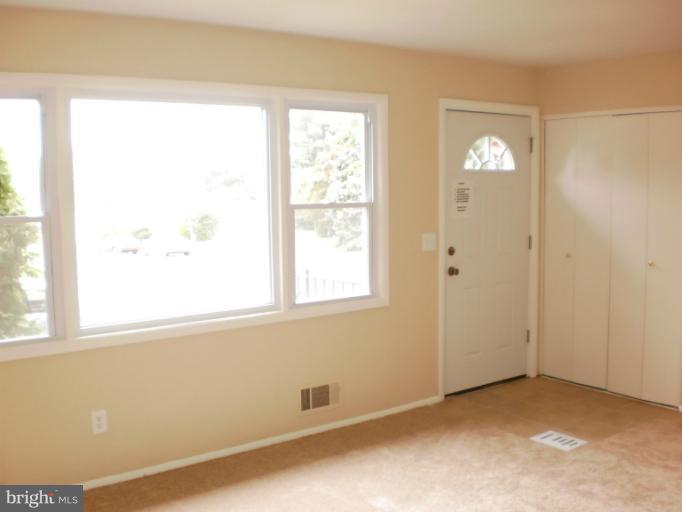 9027 Samoset Road Randallstown, MD 21133 - Photo 1 of 23 an empty room with windows