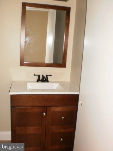 9027 Samoset Road Randallstown, MD 21133 - Photo 13 of 23 a bathroom with a sink and a mirror