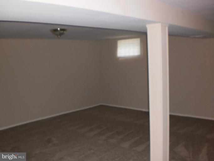 9027 Samoset Road Randallstown, MD 21133 - Photo 14 of 23 an empty room with a hallway