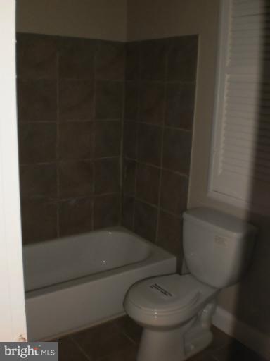 9027 Samoset Road Randallstown, MD 21133 - Photo 18 of 23 a white toilet sitting next to a bathtub