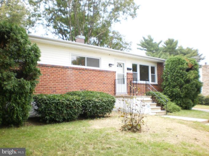 9027 Samoset Road Randallstown, MD 21133 - Photo 5 of 23 a front view of a house with a yard and garage