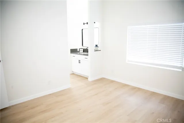 a view of a room with a wooden floor