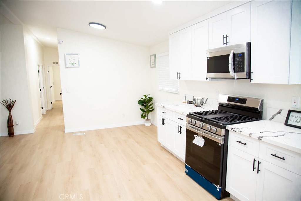 201 East Arrow Highway, Unit 73 Glendora, CA 91740 - Photo 2 of 43 a kitchen with a stove and a microwave