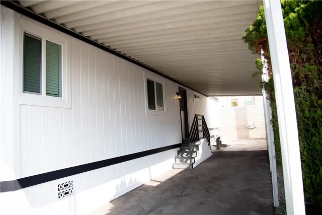 a view of a back yard with wooden door